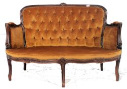 A 20th century Italian rococo two seat salon sofa settee raised on reeded supports with show wood