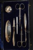 A silver hallmarked ladies manicure set  comprising scissors, pill box, files,