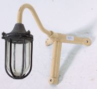 A vintage 1950's industrial dairy lamp complete with glass drop shade and cage with painted metal