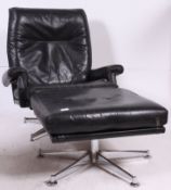 A black leather high back armchair, circa 1970, designed by Howard Keith,