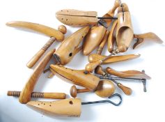 A collection of vintage mid century industrial shoe stretchers of wooden construction to include