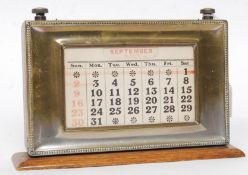 A 1930's oak and silver plated desk top calendar.