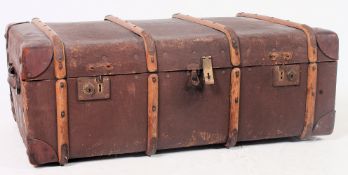 A vintage 20th century canvas and wooden bound steamer trunk with hinged centre and lined interior.