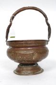 A 19th century Venetian copper bucket  having rococo embossed decoration having shaped handle atop.