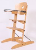 A contemporary adjustable pine Woodline  Bebe Comfort high chair.