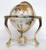 A large 20th century gemstone multi stone made globe, on a brass surround.