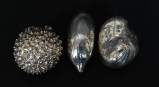 A collection of 3 silver nuts/ fruits.