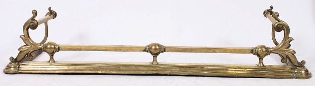 A good Victorian shaped brass fire side fender.