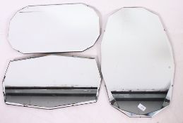 A collection of three 1930's wall hanging mirrors.