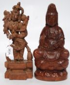 A 20th century carved Indian figure of a Deity raised on socle plinth base together with a carved