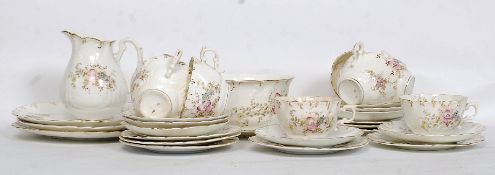 A thirty piece 19th century Victorian china tea service in a floral chintzy finish to include eight