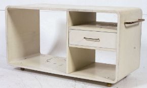 A retro 1970's white lozenge shaped coffee table of modular form with single drawer opening either