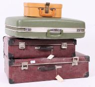 A stack of retro / vintage mid century suit cases,  to include matching,