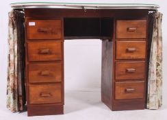 A vintage 1950's kidney shaped dressing table having pedestal drawers with curtain fronts and