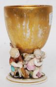 A late 19th century / early 20th century Meissen style ceramic cherub cup. Marks to base.