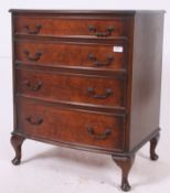 A Georgian style bow front mahogany chest of drawers having stub cabriole legs with central bank of