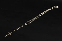 A late 19th early 20th century mother of pearl rosary beads with crucifix having a silver metal
