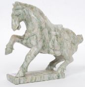 A believed 20th century Chinese decorative carved soapstone figurine of a marley horse raised on
