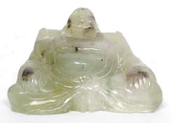 A carved jade figure of buddha, believed 20th century but possibly older.