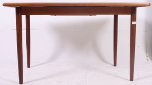 A 1970's retro teak wood Danish influence dining table with turned legs having extended centre.