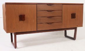 A retro 1970's teak wood veneer sideboard dresser base being raised on angular legs with central