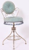 A 1950's American tubular chrome and velvet upholstered swivel salon chair.