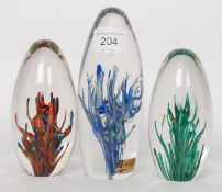 A group of three Strathearn seaweed dump paperweights the tallest being