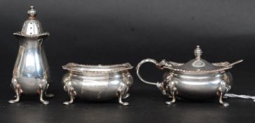 A silver hallmarked condiment set containing pepper pot,
