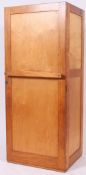 A 1950's Industrial golden oak military students locker with full length door having sectional