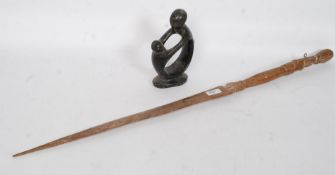 A 20th century African carved hardwood tribal spear together with a carved stone contemporary