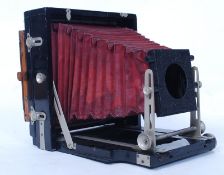 A vintage early 20th century wooden cased folding boxed bellows camera, with slides and plates.
