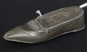 An early 19th century pewter snuff box in the form of a shoe with hinged top having chase