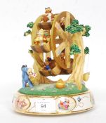 A ceramic Winnie The Pooh novelty musical Ferris wheel bearing notation to the base.