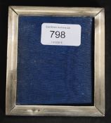 A sterling silver picture frame with reeded decoration stamped sterling. Total weight 61.