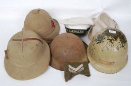 A collection of vintage military army and naval helmets to include tropical issue, 2nd world war,