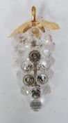 SWAROVSKI CRYSTAL ORNAMENT MODELLED AS A BUNCH OF GRAPES with gilt metal leaves and white metal