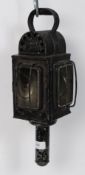 A vintage ebonised metal railway guards lamp having bevelled glass lenses with wick to inside