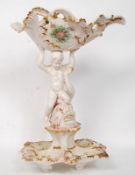 An early 20th century Italian Bassano stamped faience large ceramic figure of a cherub holding atop