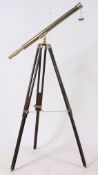 A large floorstanding teak and brass telescope.