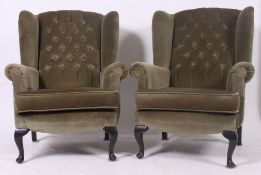 A pair of antique style wingback armchairs raised on cabriole legs with button backed green velour