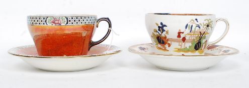 2 oversized cups and saucers, one by Maling with orange lustre finish,