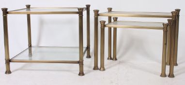 A set of 3 brass effect and glass graduating coffee tables,