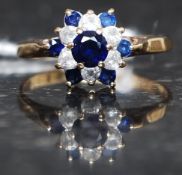 A 9ct gold, diamond and sapphire flower head ring.