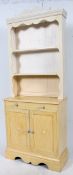 A 20th century pine painted shabby chic dresser having upright gallery plate rack over cupboard