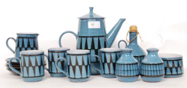 A retro Wellhouse pottery studio tea service having blue ground glaze.