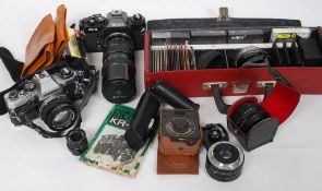 An Olympus Om - 10 35mm camera with a Ricoh KR5 m35mm camera with a Makinon F200 m lens,