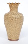 A Doulton Lambeth vase of gilded raised glaze form having tortoiseshell glazed inner with scalloped
