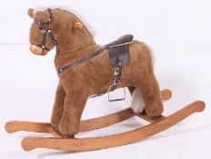 A plush rocking horse by Mamas and Papas, saddle height from floor 58cm.