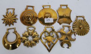 A collection of early 20th century horse brasses, mostly cast.