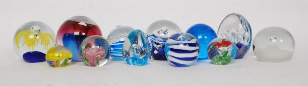 A collection of paperweights of various forms to include control bubble form,